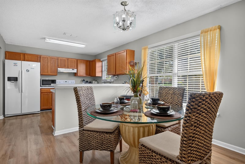 Kitchen with dining table and white refrigerator at 8680 Bandera Cir S, Jacksonville, FL 32244