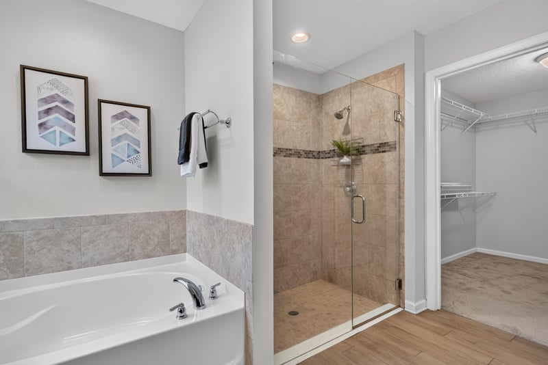 Primary bathroom with soaking tub, shower and walk-in closet at 10066 Andean Fox Dr, Jacksonville, FL 32222