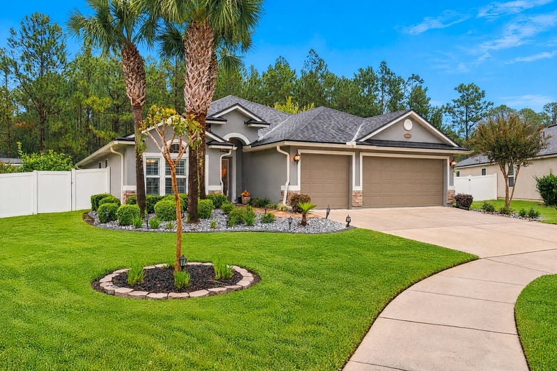 Front yard with palm trees and manicured lawn at 10923 Black Diamond Ct, Jacksonville, FL