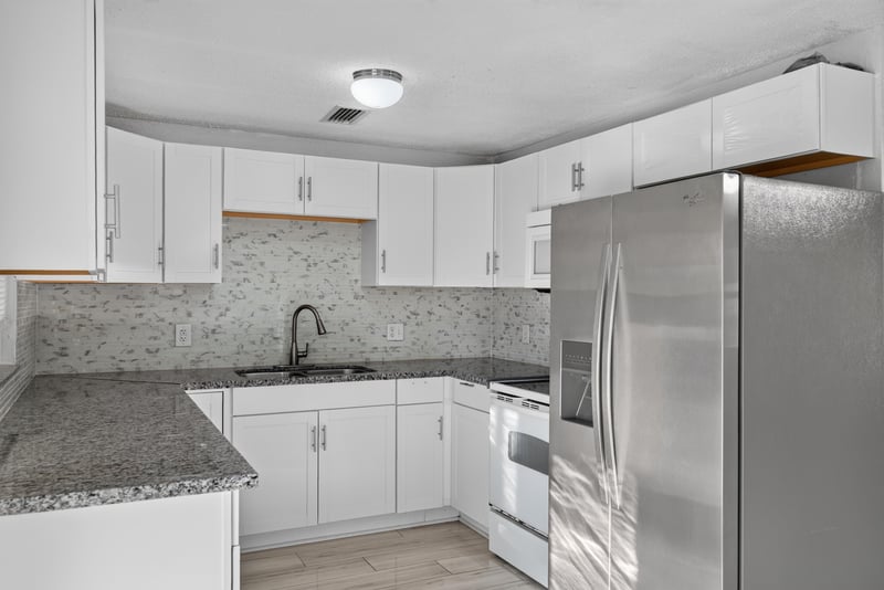 Kitchen with white cabinets and stainless refrigerator at 442 Ameca Ave, Orange Park, FL 32073