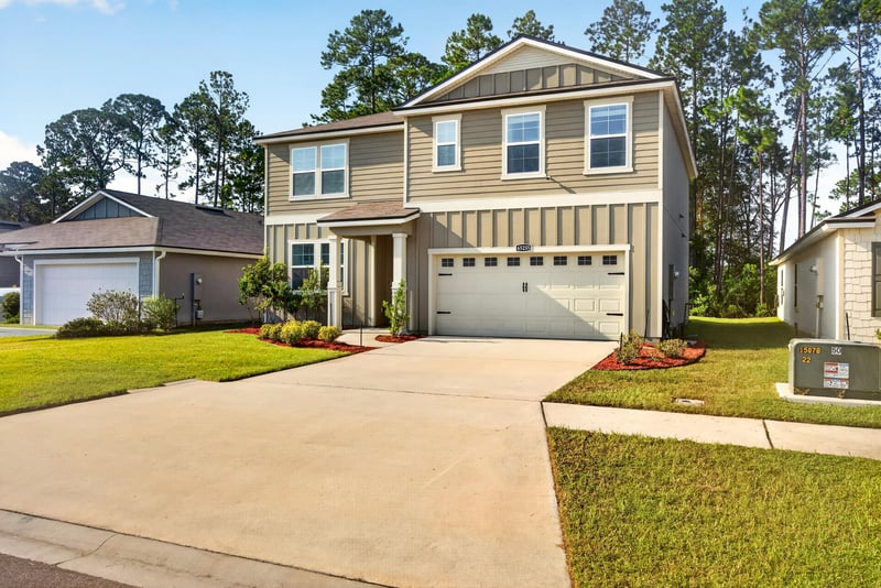 Front exterior view from street showing garage and walkway at 65255 Frst Glen Ln, Yulee, FL 32097