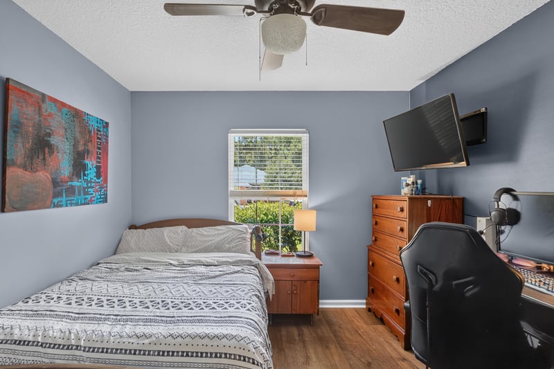 Bedroom with dresser and window light at 1589 Backwater Drive, Middleburg, FL 32068