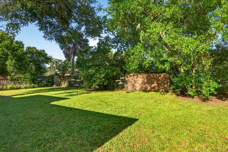 Backyard lawn with mature trees at 6338 Mercer Cir W, Jacksonville, FL