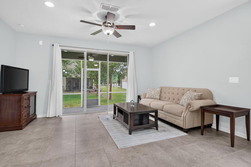 Living room with television and sliding glass door at 2378 Caney Oaks Dr, Jacksonville, FL