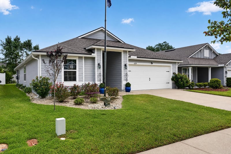 Front exterior close-up with landscaped lawn at 4319 Green River Pl, Middleburg, FL 32068