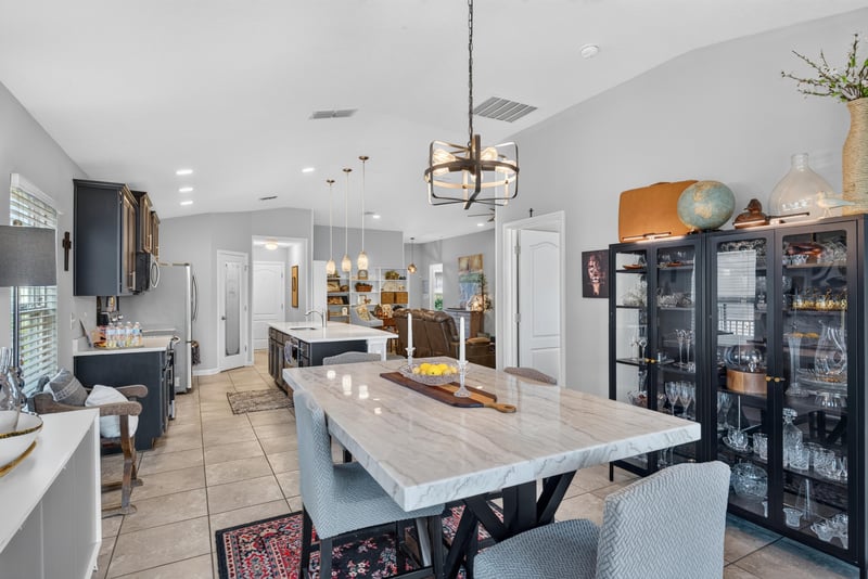 Dining table with chandelier and built-in shelving at 589 Seville Pkwy, St. Augustine, FL