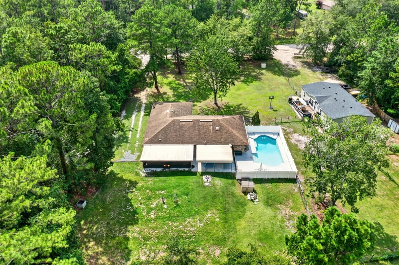 Aerial view of the home, pool and fenced yard at 2435 Range Line Rd, Middleburg, FL