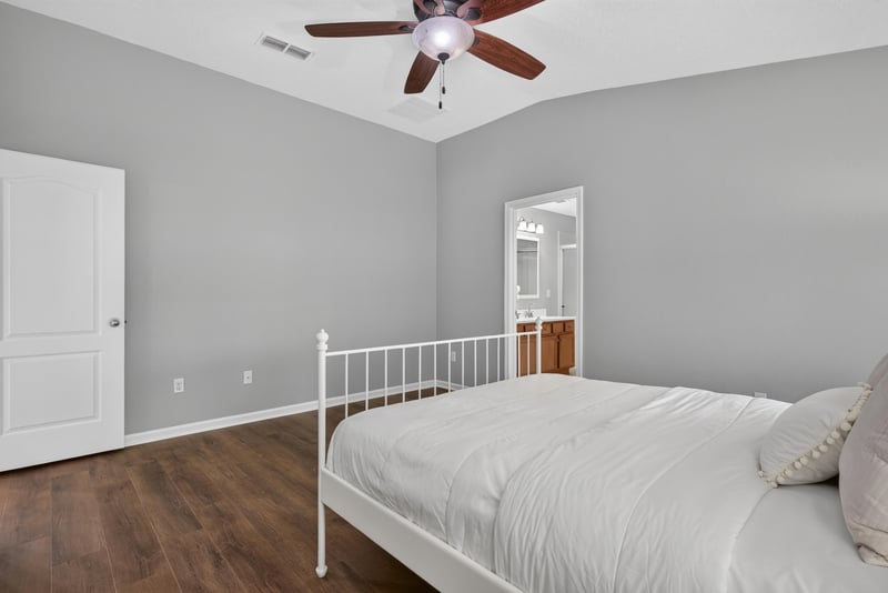 Bedroom with staged bed at 706 Grampian Highlands Dr, St. Johns, FL 32259