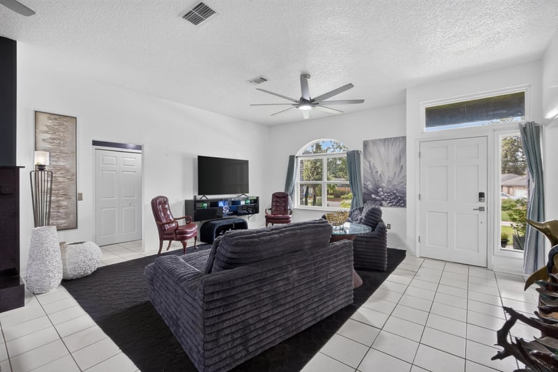 Living room with television and arched window at 1346 Gately Ct, Jacksonville, FL 32225
