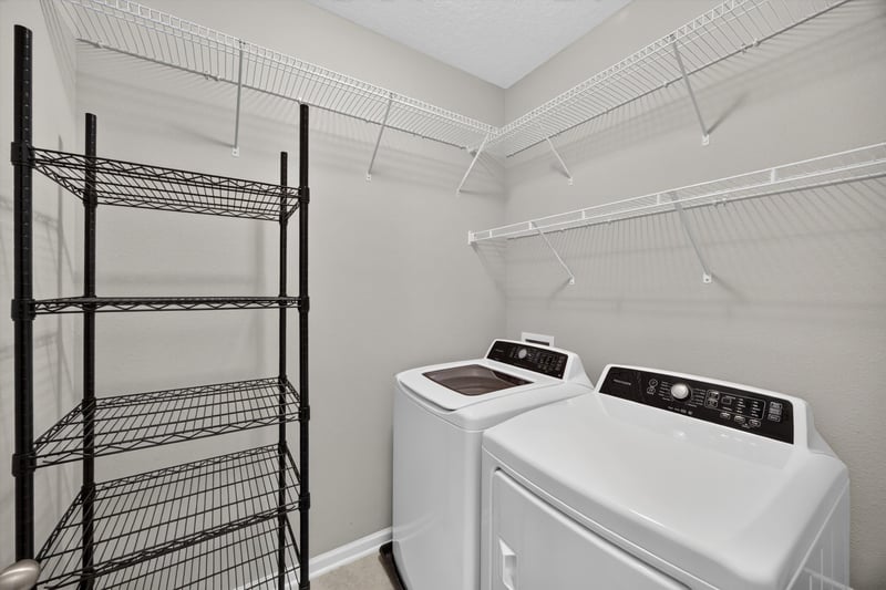 Laundry closet with wire shelving and washer dryer at 75875 Saffron Ln, Yulee, FL 32097