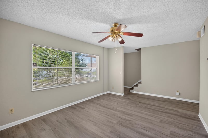 Empty living room with wood-look flooring and a front window at 2658 Trollie Ln apt 1, Jacksonville, FL 32211