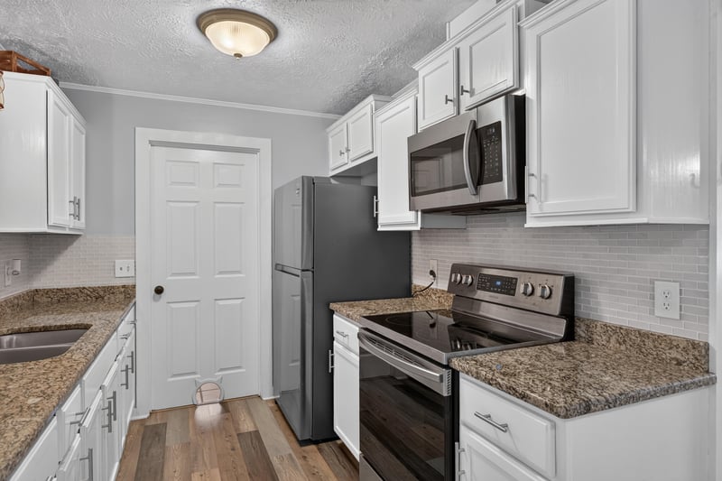 Kitchen with stainless range and granite counters at 6757 Deer Springs Rd, Keystone Heights, FL 32656