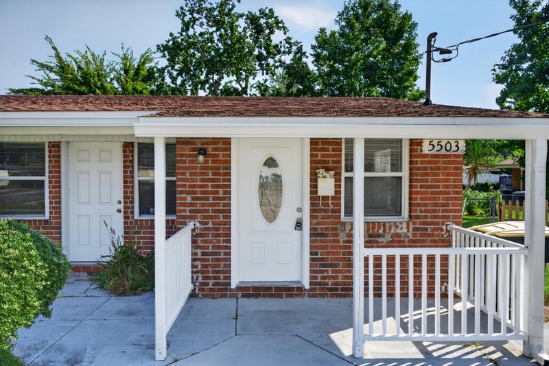 Front door and covered porch with white railing at 5503 Boeing Dr, Jacksonville, FL 32207
