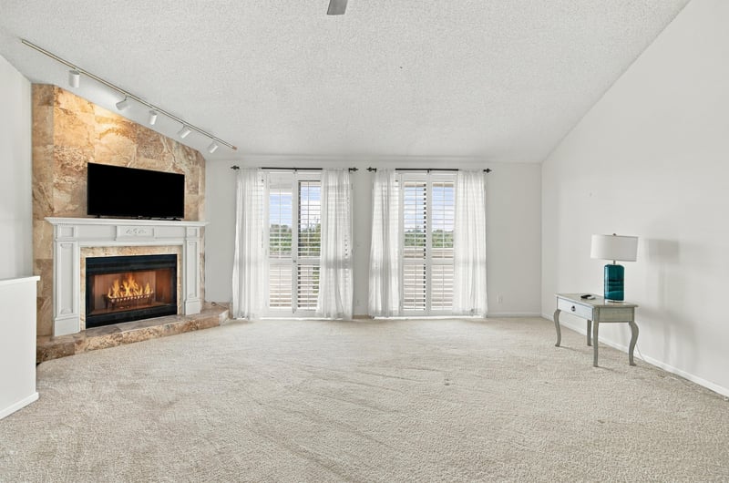 Empty living room with fireplace and carpet at 752 Spinnakers Reach Dr, Ponte Vedra Beach, FL 32082