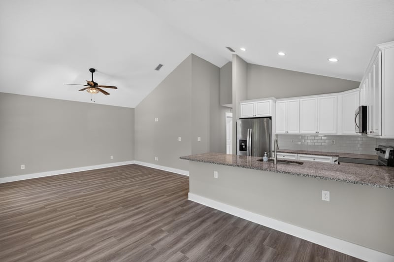 Kitchen peninsula with white cabinets and appliances at 2855 N 8th St, St. Augustine, FL 32084
