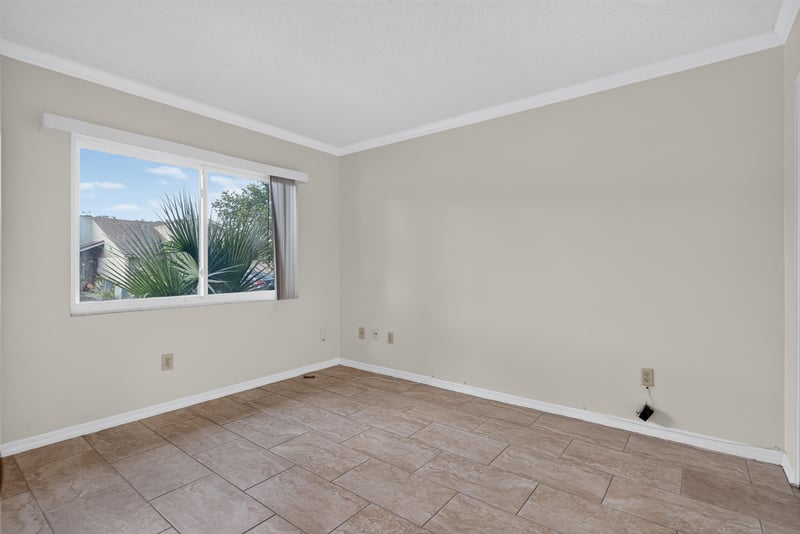 Bedroom with window and tile flooring at 3515 Cormorant Branch Ct, Jacksonville, FL