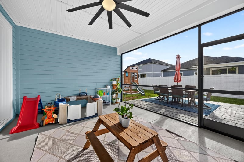Flex room with blue accent wall opening to the lanai at 2354 Jennings Farm Dr, Middleburg, FL 32068