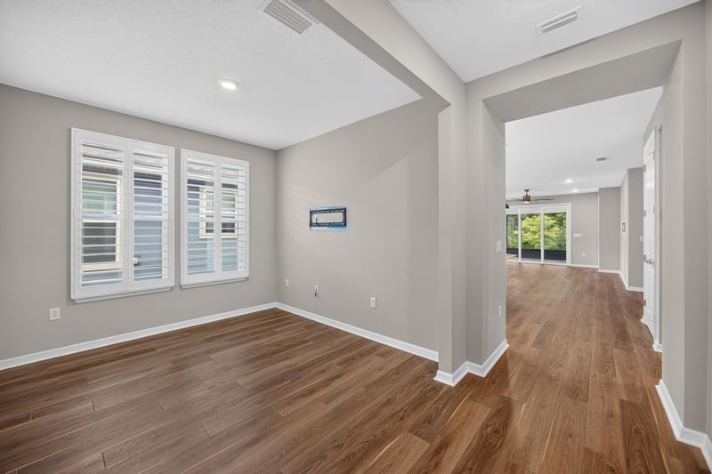 Entry hallway with wood floors leading to the living area at 171 Oyster Shell Ter, Nocatee, FL 32081