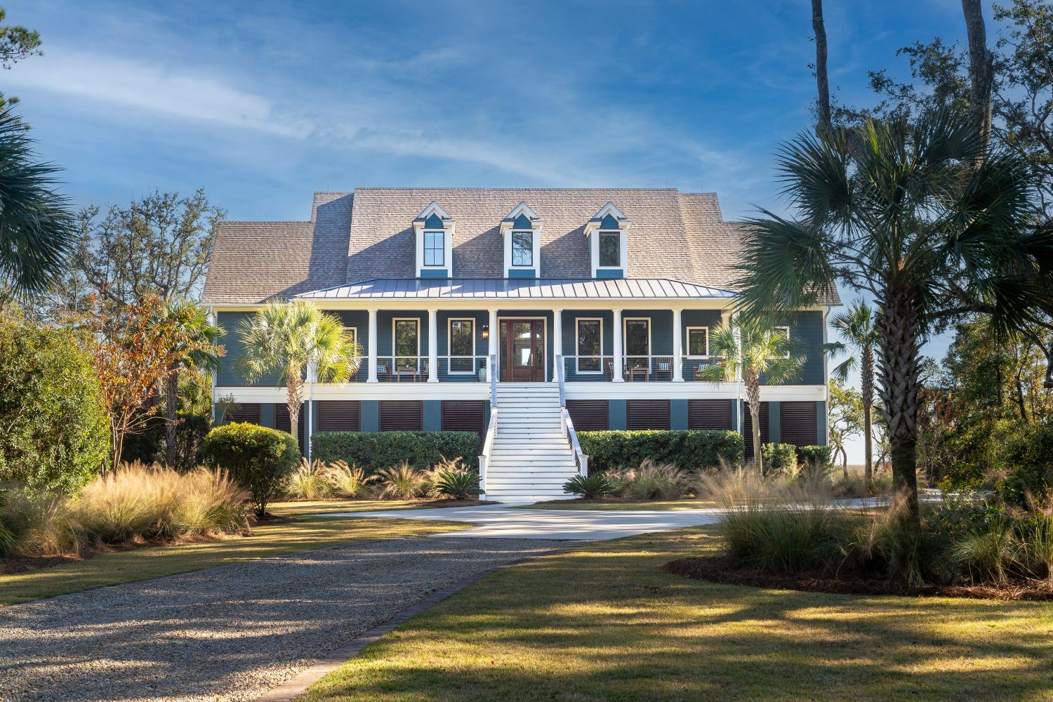 Lowcountry home with a wide front porch under a clear blue sky