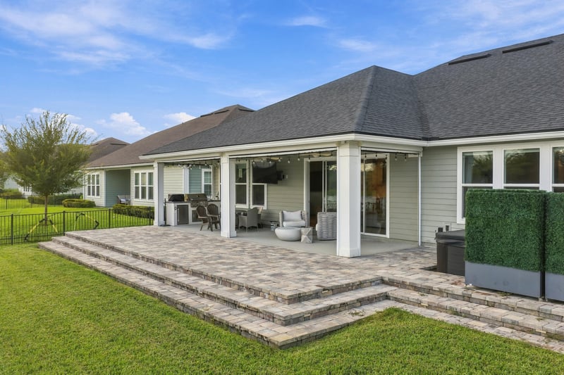 Back patio with paver steps and covered porch at 3921 Spyglass Hill Ln