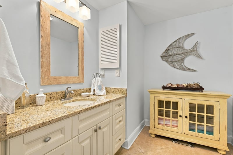 Bathroom vanity with mirror and fish decor at 805 Spinnakers Reach Dr, Ponte Vedra Beach, FL 32082