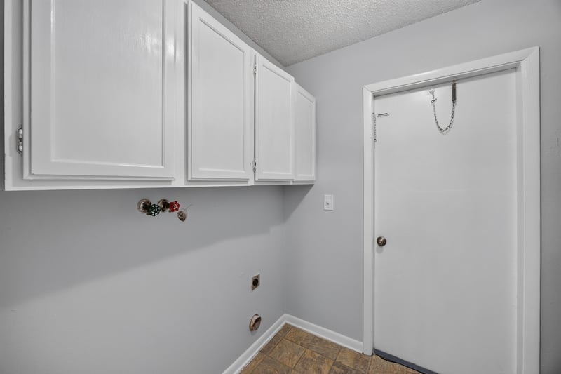 Laundry area with white cabinets and door at 328 Palos Ct, St. Augustine, FL