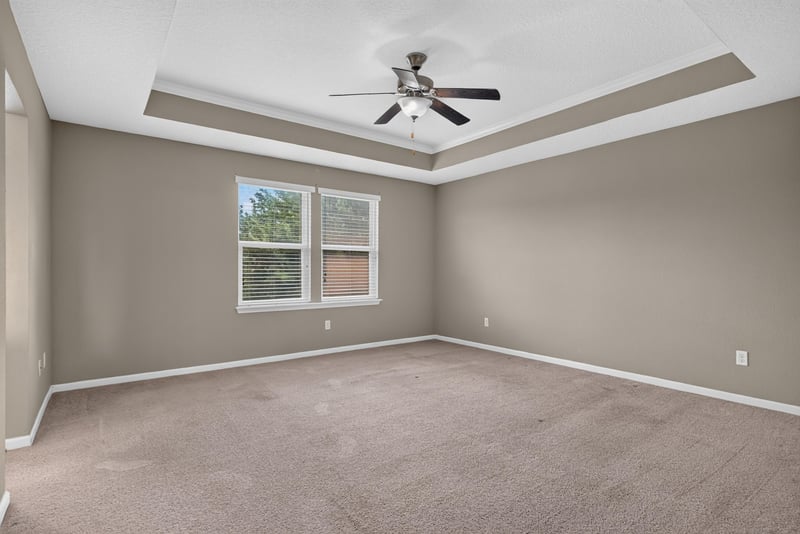 Bedroom with tray ceiling and ceiling fan at 263 Gilmore Ln, Orange Park, FL 32065