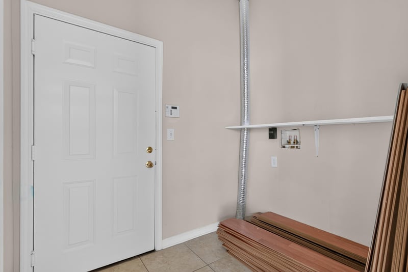 Side door and tiled utility area at 7047 Deer Lodge Cir, Jacksonville