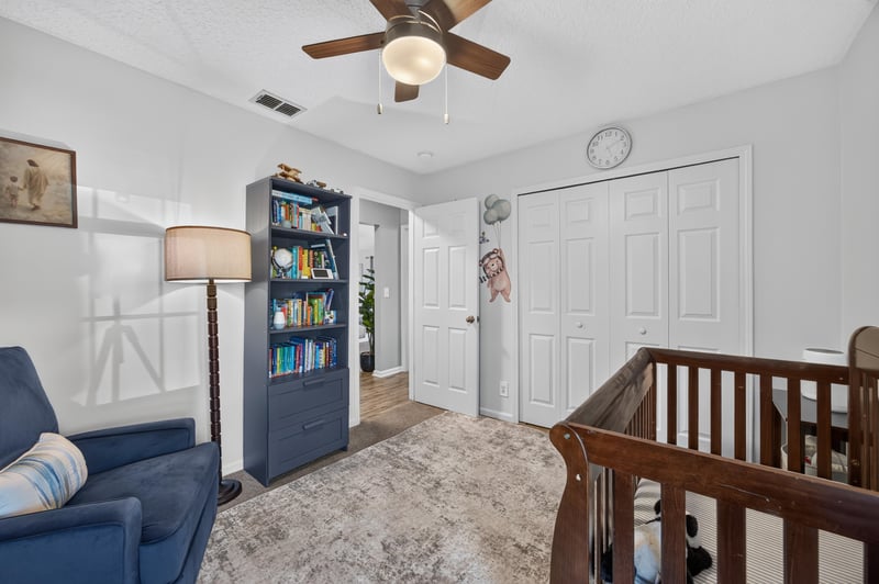 Bedroom with bookshelf and blue sofa at 12825 Kelsey Island Dr, Jacksonville, FL 32224