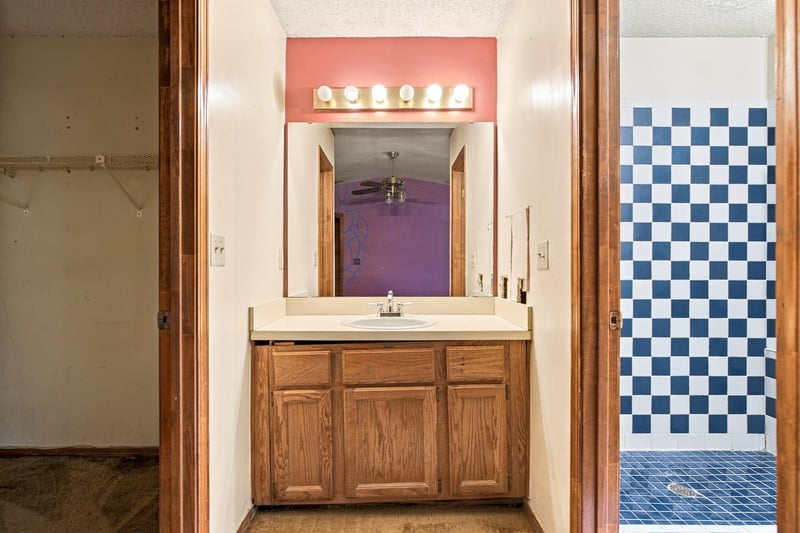 Bathroom vanity with wood cabinet and pink wall at 2915 Trenton Ct, Orange Park, FL