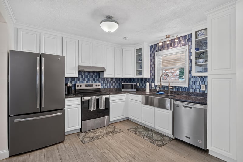 Kitchen with stainless refrigerator and tile backsplash at 6059 Karen St, Jacksonville, FL 32244