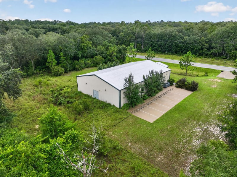 Drone aerial of the building and front lawn at 1038 County Rd 315, Melrose