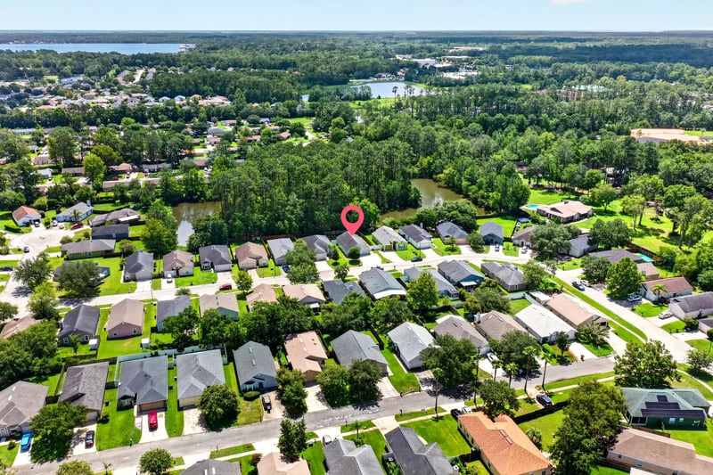 Drone aerial of neighborhood with lake view in Middleburg, FL