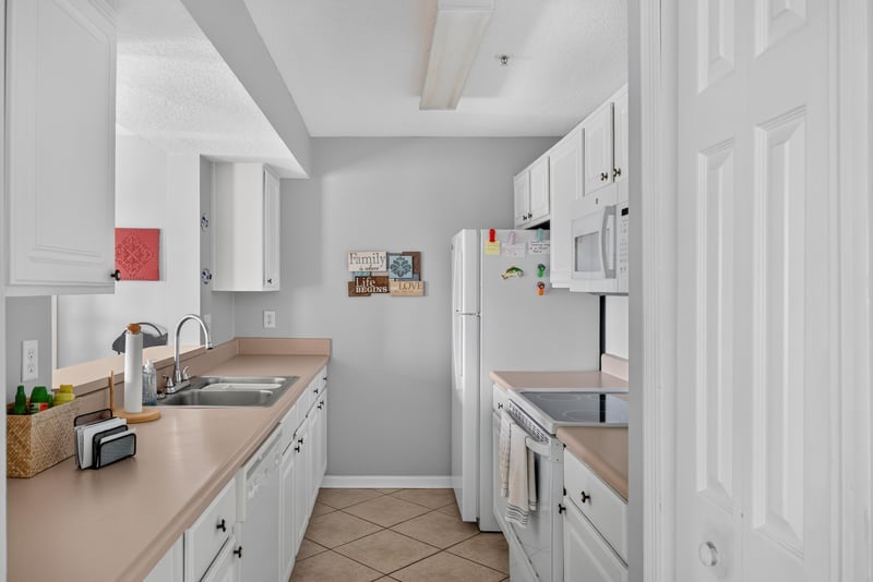 Kitchen counter and sink with white cabinetry at 206 16th St, St. Augustine, FL 32080