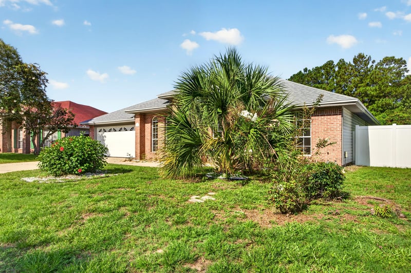 Front exterior with palm trees and brick facade at 11828 Heather Grove Ln, Jacksonville, FL