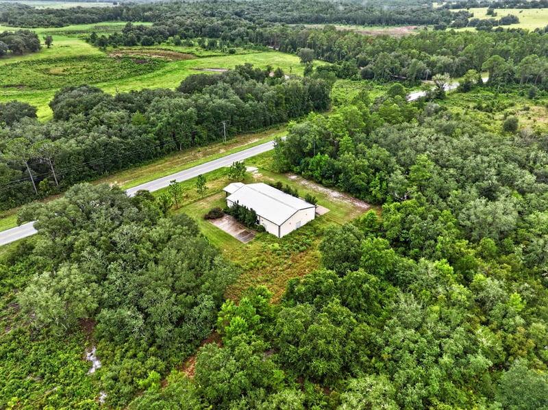 Drone aerial of the building and driveway from the road at 1038 County Rd 315, Melrose