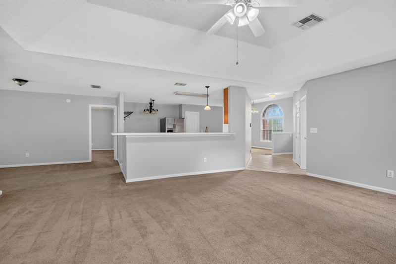 Kitchen bar opening to the living room at 11669 Collins Creek Dr, Jacksonville, FL 32258