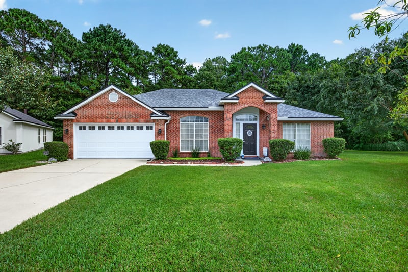 Front exterior, brick home with three-car garage at 13514 Las Brisas Way N, Jacksonville, FL