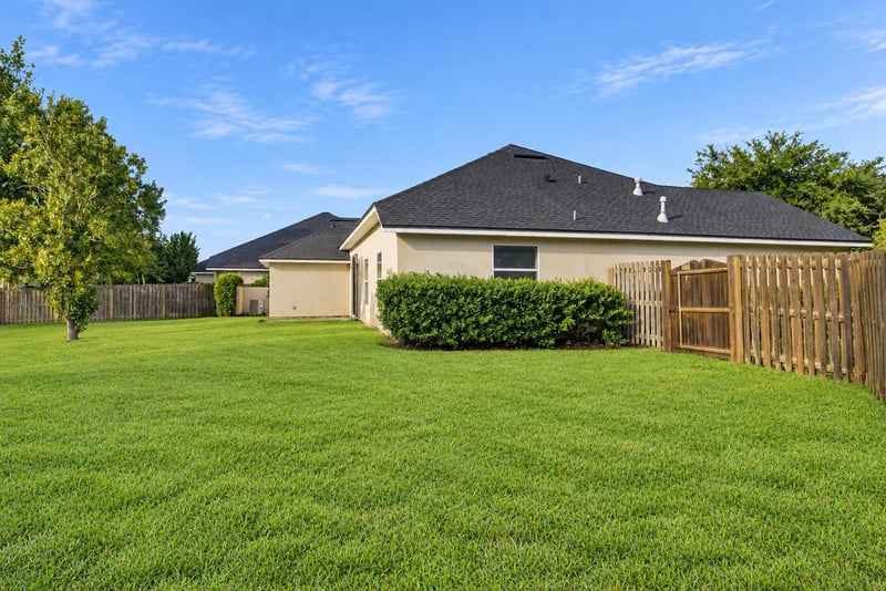Backyard with fenced yard and side gate at 14187 Big Spring St, Jacksonville, FL 32258