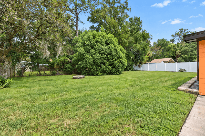 Backyard lawn with trees and fence at 4039 Habana Ave, Jacksonville, FL