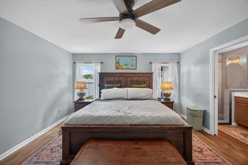 Bedroom with large bed and nightstands at 1589 Backwater Drive, Middleburg, FL 32068