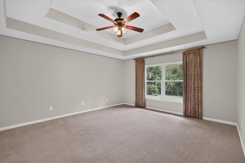 Empty bedroom with tray ceiling and window at 1955 GUARDED Way, Fleming Island, FL 32003