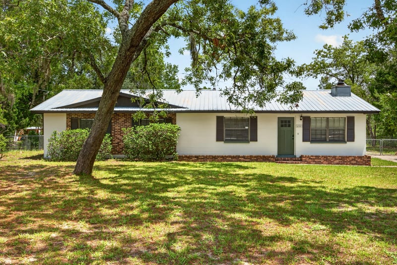Front exterior with white siding and metal roof at 6757 Deer Springs Rd, Keystone Heights, FL 32656