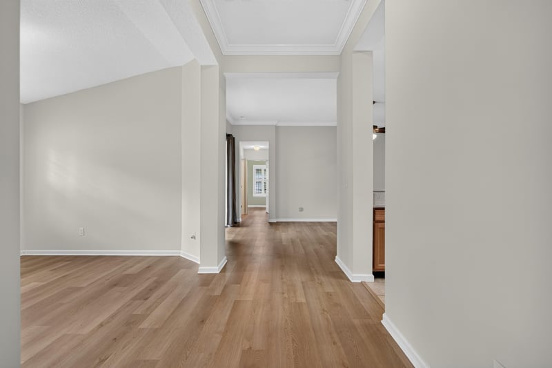 Hallway with wood floors leading to living area at 2131 E Stone Creek Dr, Fleming Island, FL