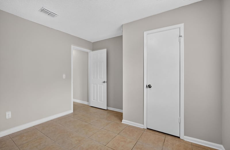 Bedroom with closet doors at 1040 Willow Cove Ct E, Jacksonville, FL 32233