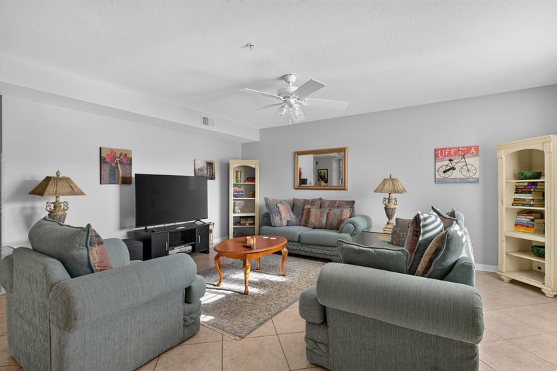 Living room seating area with television and lamps at 206 16th St, St. Augustine, FL 32080
