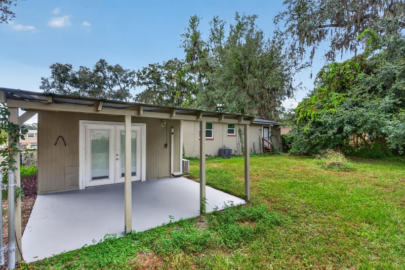 Covered patio with French doors overlooking backyard at 217 Baisden Rd, Jacksonville, FL 32218