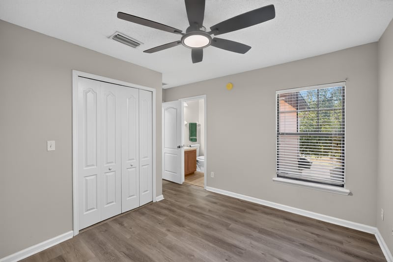 Bedroom with closet doors and window at 7723 Playschool Ln, Jacksonville, FL