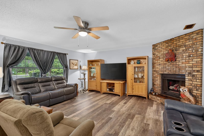 Panoramic view of living room with fireplace and sectional at 3249 Maryland Ave, Green Cove Springs, FL