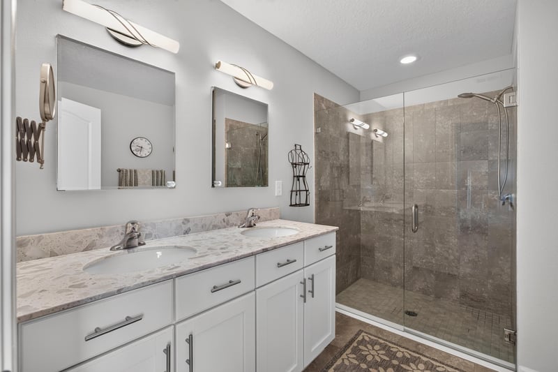 Primary bathroom with double vanity and glass shower at 85 Amia Dr, St. Augustine, FL 32086